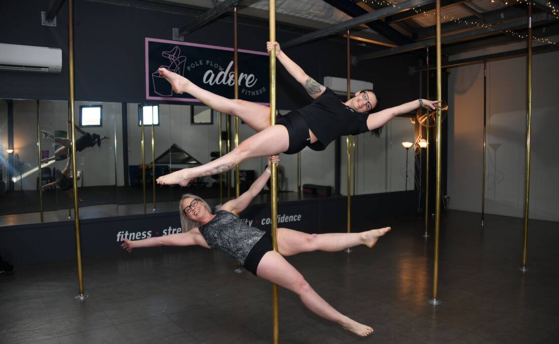 Rebekah Taylor and Toni Naden doing one of their tricks on the pole. Picture: Amy McIntyre