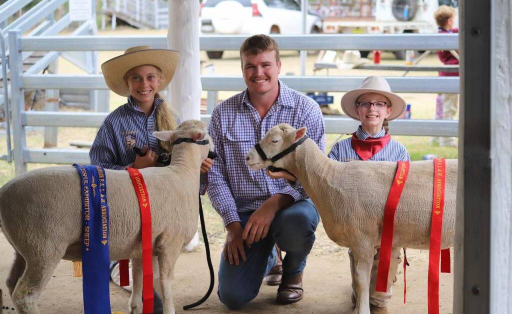 Jed McEvoy with some young kids showing sheep. Picture supplied 