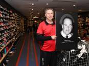 Anthony Barnes stands with a picture of his late father Brian Barnes in 'Brian Barnes Sportspower'. Picture by Amy McIntyre 