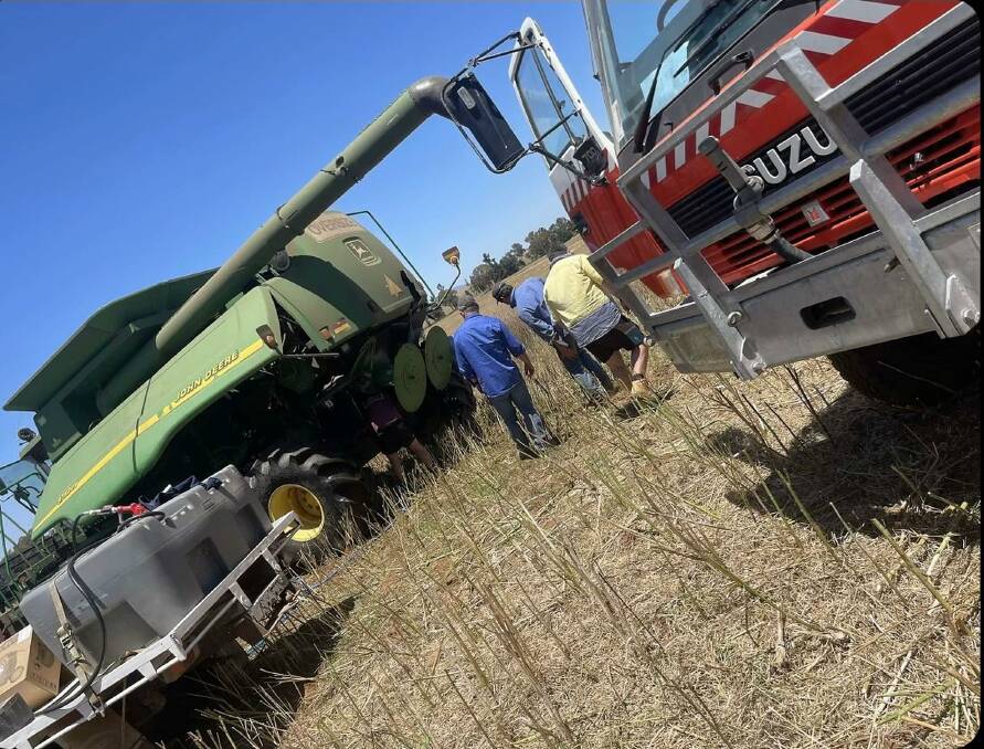 The day before Emma and Tom Hurst got married their header was burnt out while direct heading canola. Photo: Supplied
