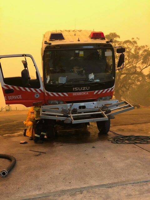 A mechanic works on one of Bemboka's RFS trucks during the height of Black Summer bushfires.