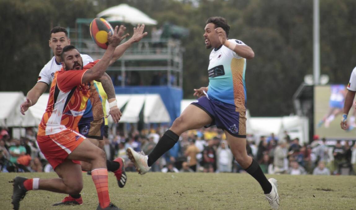 NOT THIS TIME: South Coast Black Cockatoos' Paul Roberts puts a kick through during last year's Koori Knockout final. Photo: GRAHAM SUTCH