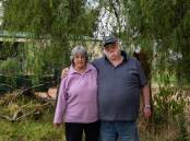 Cherie and Raymond Bennett in front of the tree that saved their lives in Eugowra, NSW. (AAP Image/Rebecca Bennett) 