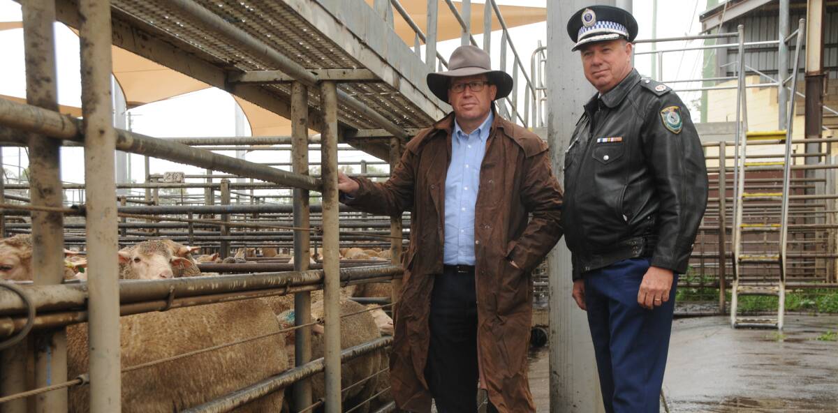 RURAL REPORTING: Minister for Police Troy Grant and Western Region Commander Geoff McKechnie, Dubbo Saleyards. Photo: GRACE RYAN.