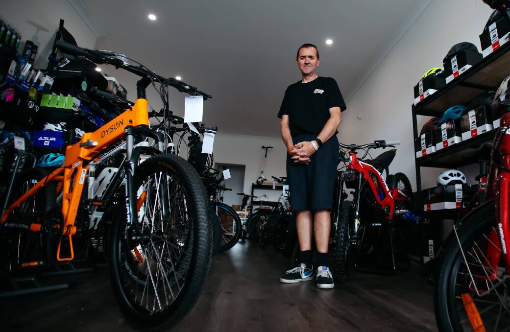  Fan: Corrimal e-bike store owner Andrew Larkham is a fan of that mode of transport, and would like to see the laws around e-scooters relaxed. Picture: Wesley Lonergan