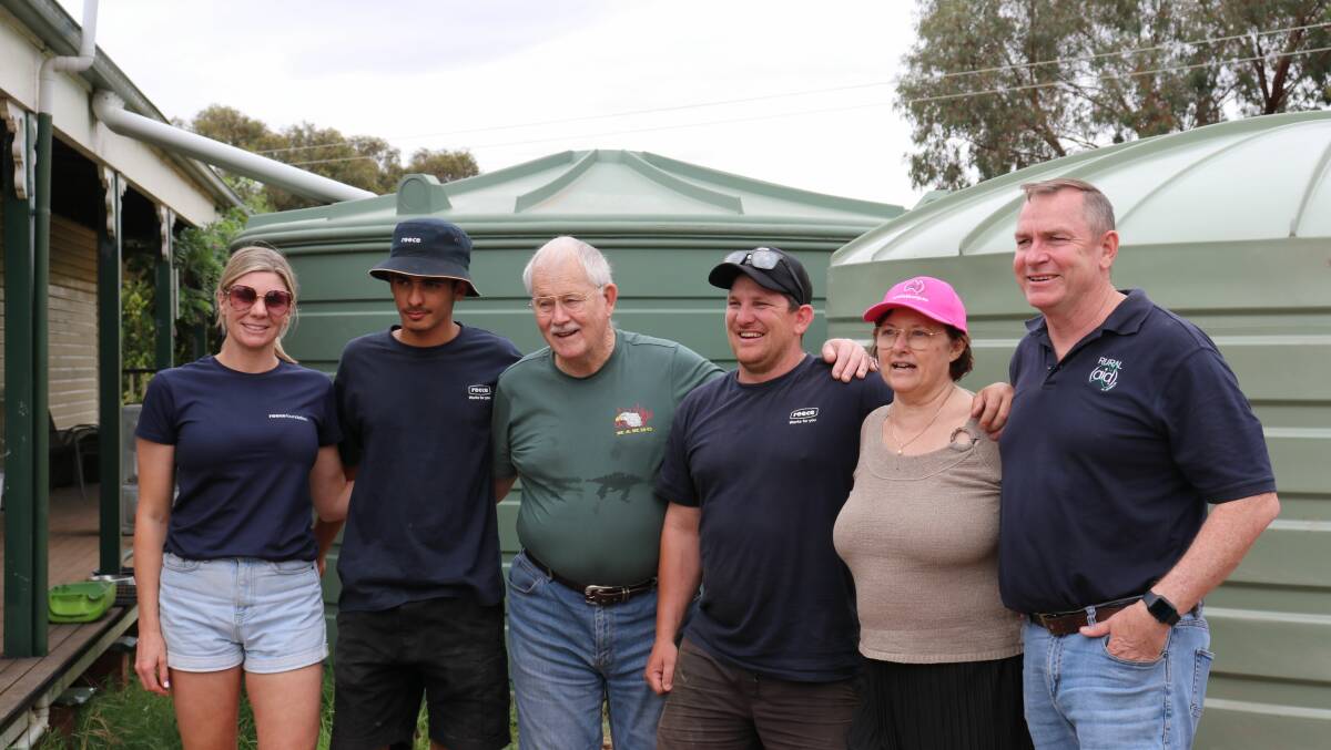 Robert and Linda Ireland with Ashleigh Sheridan from the Reece Foundation, volunteer plumbers Ali Hassan and James Woolford, and Brian Morton from Rural Aid. Picture supplied 