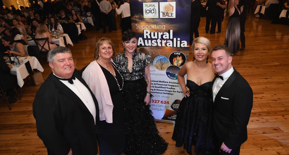 Charles and Tracy Alder, left, pictured with Em Rusciano, and Chezzi and Grant Denyer, at a 2018 fundraising ball. Photo - CHRIS SEABROOK 081118cboots