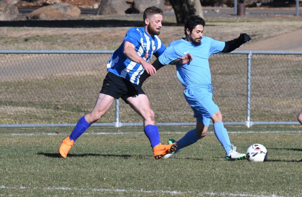 IT'S BACK: Football will be played again in Orange this weekend. This is Liam McCormack and David Moses battling for the ball last year. Photo: CARLA FREEDMAN
