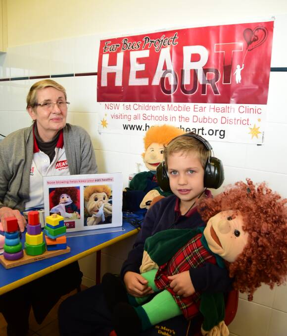 CAN YOU HEAR US?: Audiologist Robyn Little tests year 1B student Cooper Lord's ears. Photo: BELINDA SOOLE