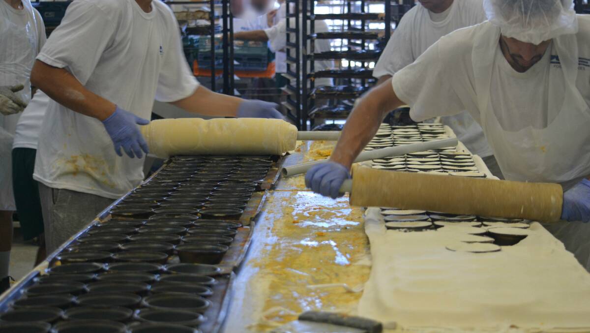 Hard at work: Inmates at Wellington Correctional Centre work at making meat pies and loaves of bread in the bakery. Photo: Daniel Shirkie.