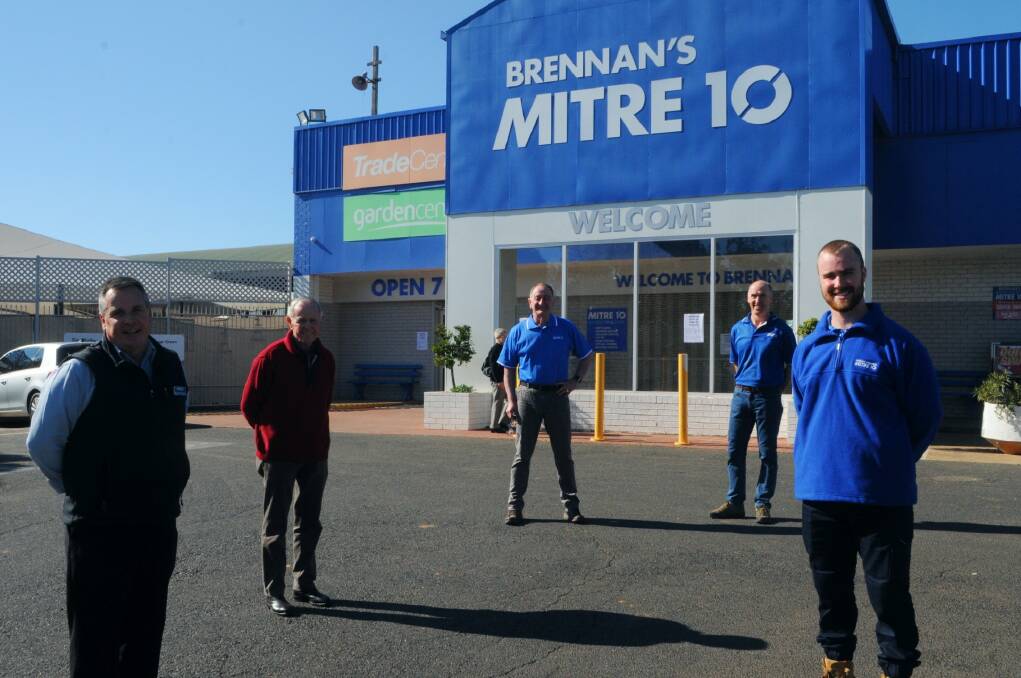 New era: Brennan's Mitre 10 managing director Michael Brennan and governing director Frank Brennan prepare to hand over to Michael Fergus, Phillip Petrie and Brad Petrie of the Petrie Group. Photo: FAYE WHEELER