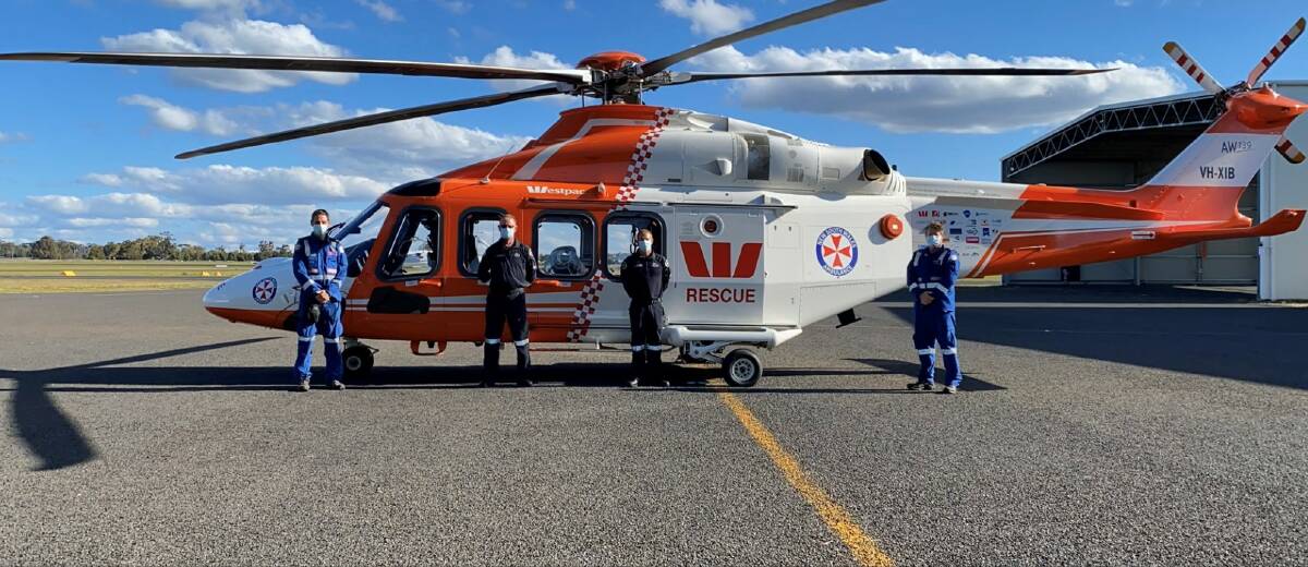 ADDITIONAL RESOURCE: A surge helicopter, pictured with Dr Brian Burns, Mike de Winton, Michael Legge and Matt Moore, will be based in Dubbo until December to assist with NSW Ambulance's COVID-19 response. Photo: CONTRIBUTED