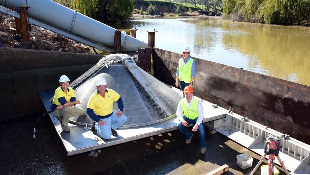 FISH ARE FRIENDS: Dr Craig Boys, Shane Smith, Sam Davis and Matt Hansen beside one of the variations of fish screen being installed at the Gin Gin weir. PHOTO: BELINDA SOOLE.