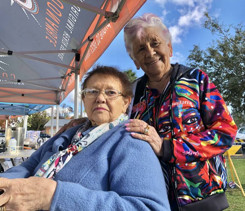 ELDERS: Aunty Fay Crowe and Aunty Violet West catch up at the National Sorry Day event at Dubbo on Wednesday. Photo: KIM BARTLEY.