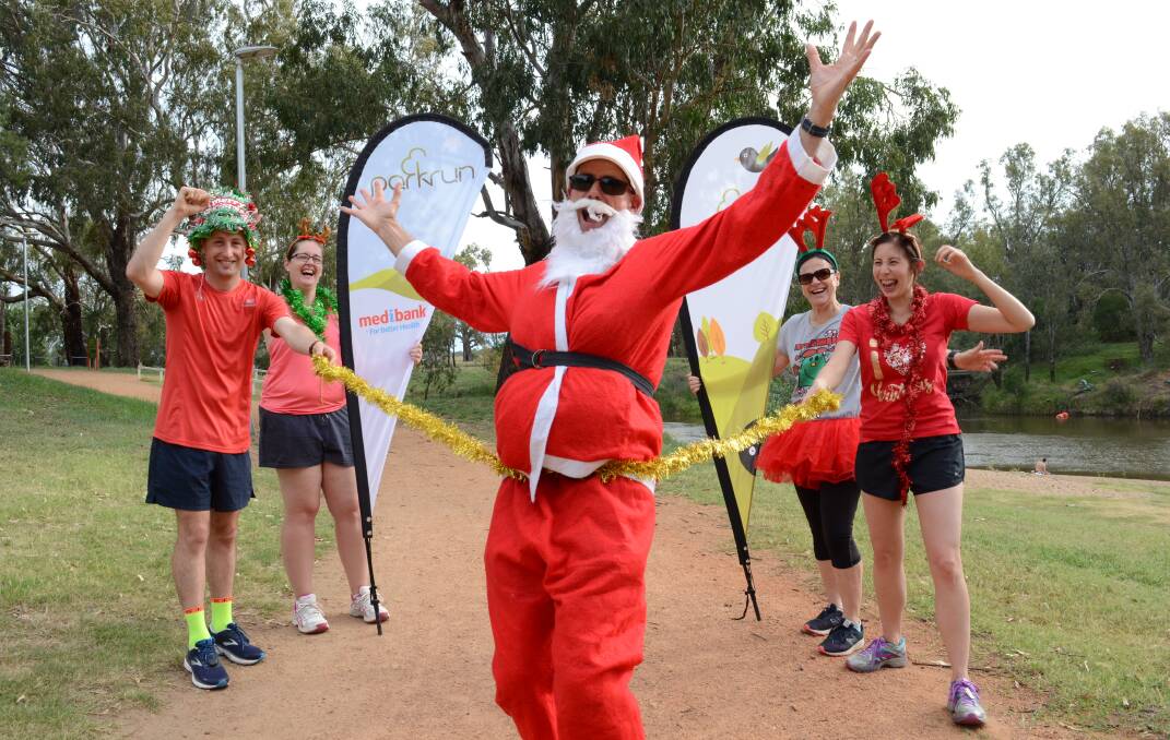 Dubbo parkrun run directors Tim Morris, Lynn Rayner, John Robins (as Santa), Karen Pellow and event director Miriam Tan are excited about taking part in Dubbo parkrun on Christmas Day. Photo: MARK RAYNER