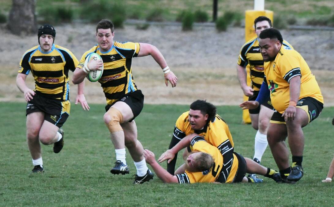 CSU fullback Jonathon Lally leaves these Dubbo Rhinos in his wake during Saturday's New Holland Cup clash. He's the fourth different fullback for CSU this season. Picture: Chris Seabrook