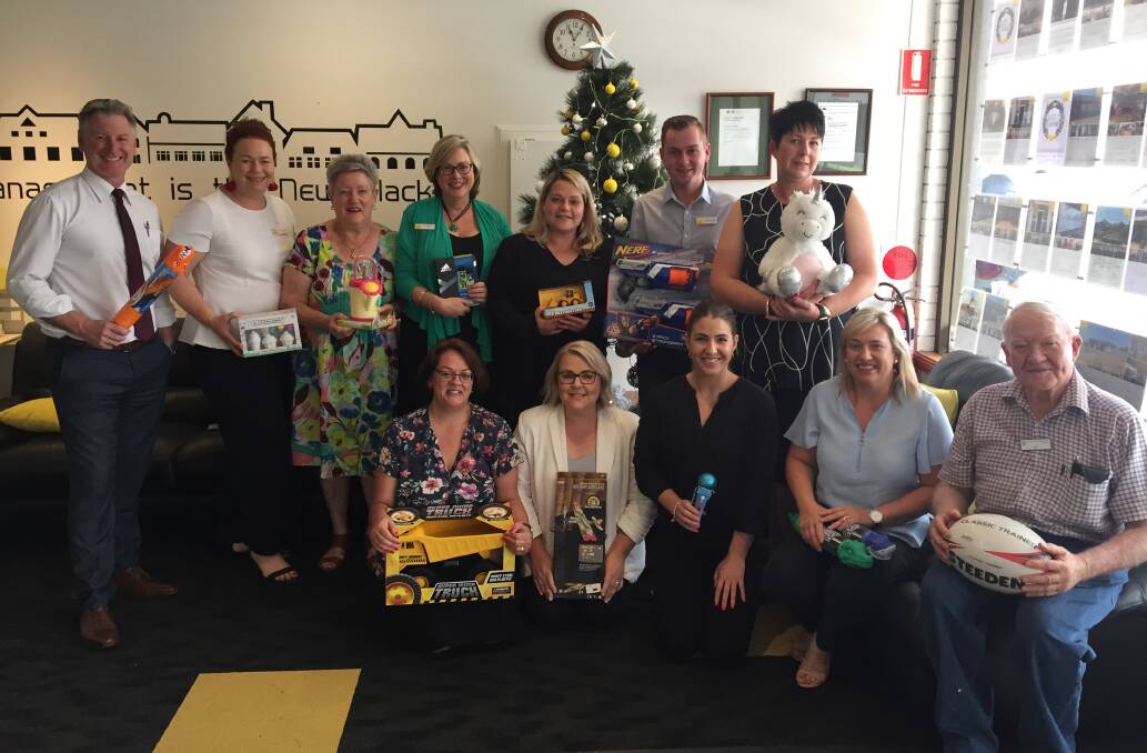 CHRISTMAS GIVERS: Ray White Dubbo staff with Vinnies volunteers Carole O'Connor and Dan Sullivan. Photo: RYAN YOUNG