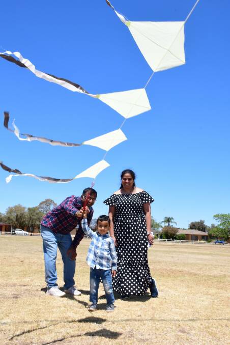 FAMILY FUN: Puneet and Manisha Wadhwa introduce their son Kiyansh to kite flying at Jubilee Oval in Dubbo. Photo: AMY McINTYRE