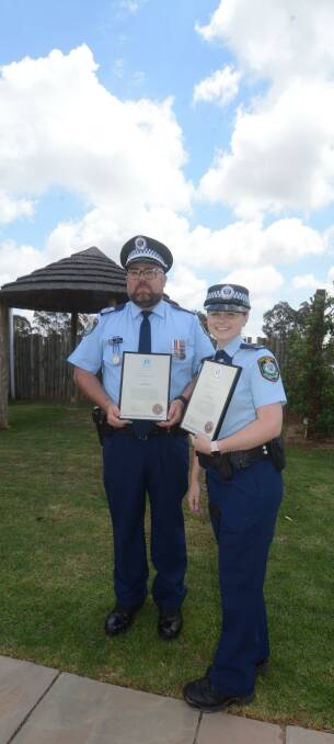 BRAVE OFFICERS: Senior Sergeant Michael Smith and Constable Alexandra Dwyer with the awards they received. Photo: RYAN YOUNG