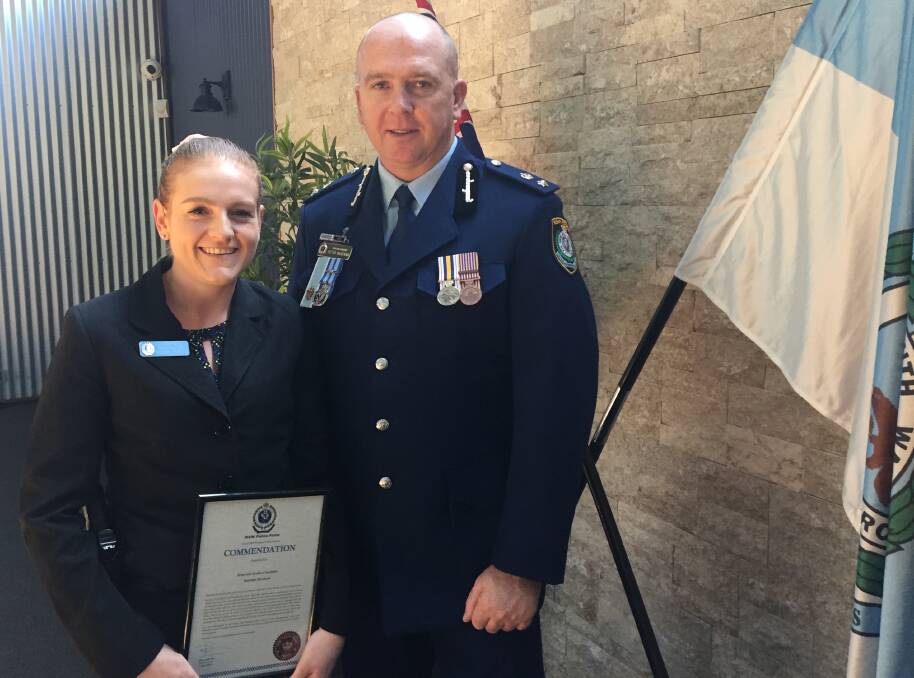 HUMBLE HERO: Detective Senior Constable Katrina Sherlock with the award she received from Superintendent Peter McKenna.