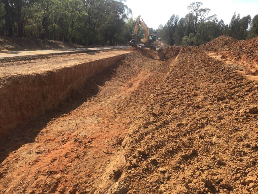 REPAIRS: Authorities clean up a section of the Golden Highway near Elong Elong. Photo: SUPPLIED