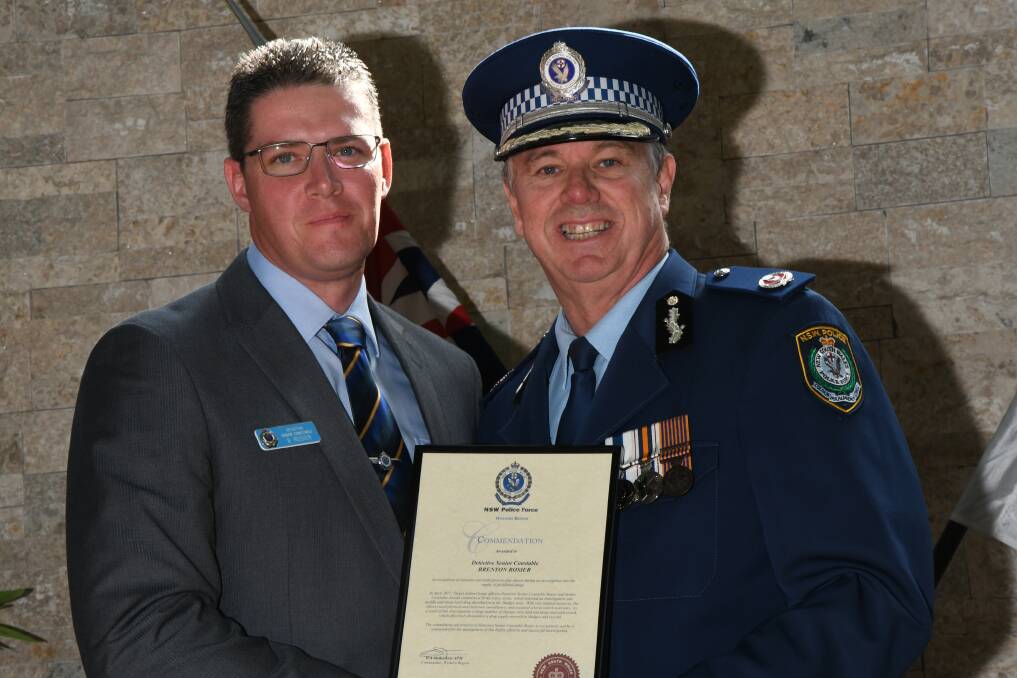 WORK RECOGNISED: Detective Senior Constable Brenton Rosier receiving his award from NSW Police Assistant Commissioner Geoff McKechnie.