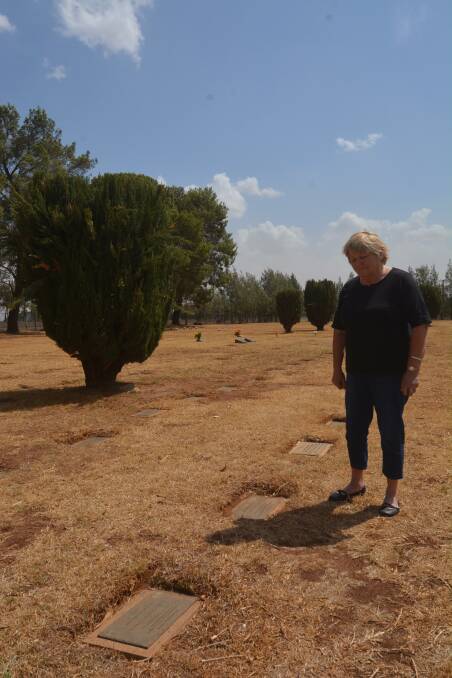 UPSET: Bev McGrath at her father's final resting place in Dubbo. Photo: RYAN YOUNG