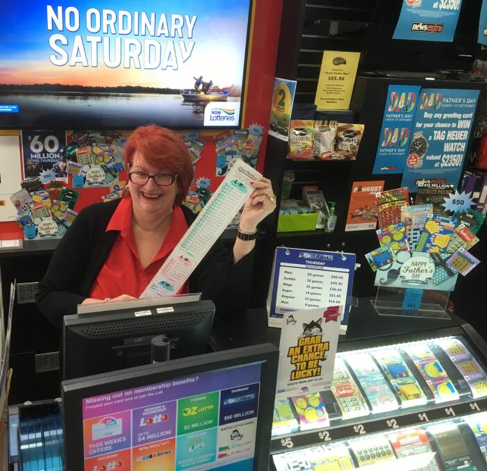 LUCKY CITY: Newsextra on Macquarie assistant manager Lee Judd sold one of the winning lotto tickets. Photo: RYAN YOUNG