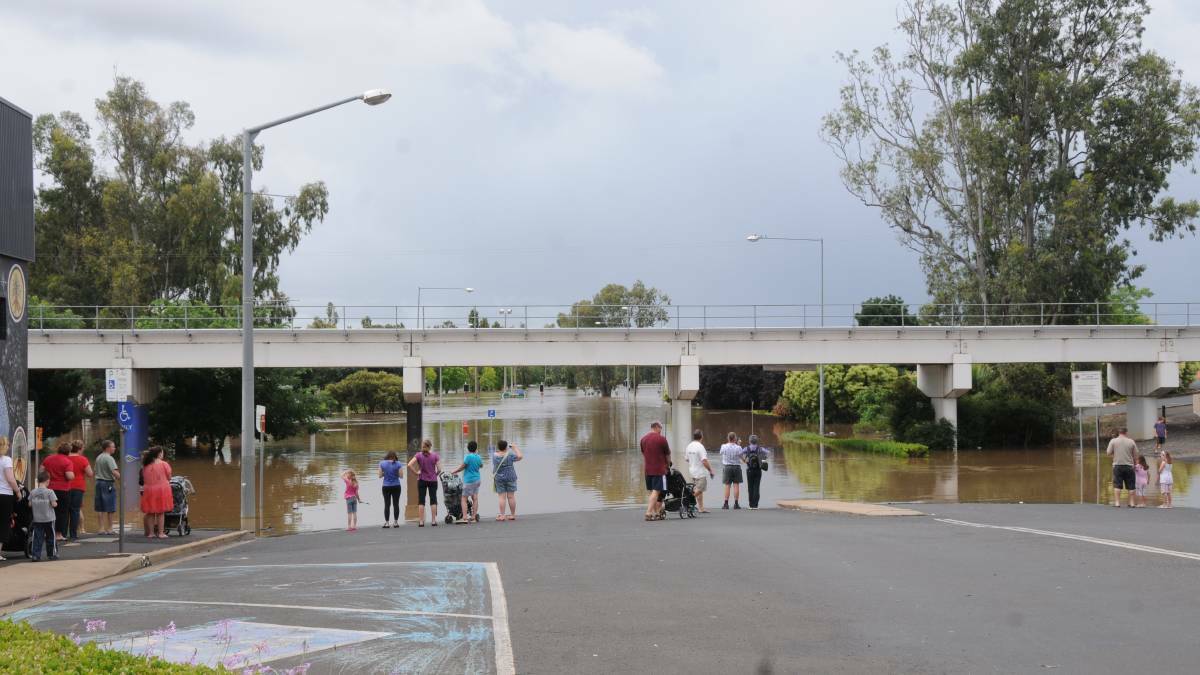 ROADS SUBMERGED: Residents marvel at the flood waters in 2015.