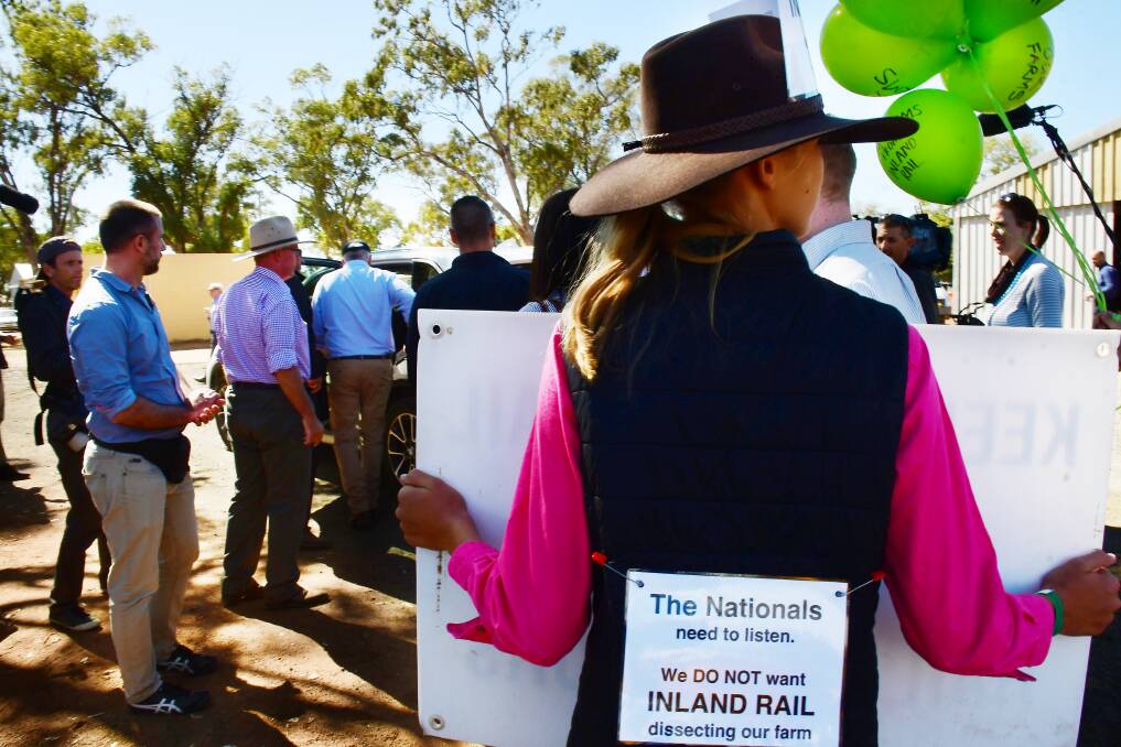 LEAVING SHOW: Prime Minister Scott Morrison farewells showgoers as an inland rail protester watches on. Photo: BELINDA SOOLE