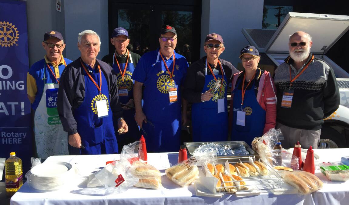 FEEDING THE MOB: Rotary Club of Dubbo West members tempted taste buds with the sausage sizzle they put on. Photo: RYAN YOUNG