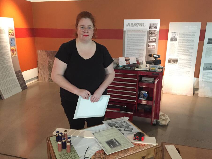 SHOWCASING LOCAL HISTORY: Western Plains Cultural Centre collections officer and Mad Mossy exhibition curator Jessica Moore working on the exhibition ahead of its opening on Saturday. Photo: RYAN YOUNG