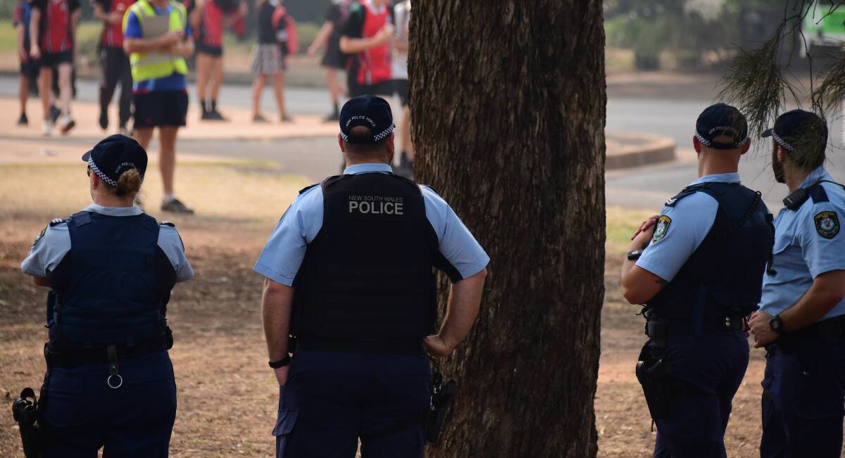 DAMAGE CONTROL: Police monitor students at the Dubbo College South Campus after a 16-year-old boy allegedly attacked another boy with a knife last week. Photo: BELINDA SOOLE
