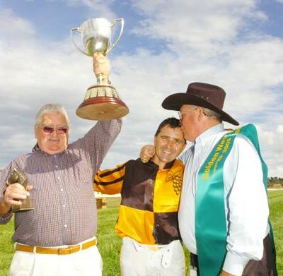 CELEBRATION TIME: Owner Lance Smith, jockey Neil Paine and trainer Max Crockett with the spoils of King’s Consul’s Orange Gold Cup win in 2006. Photo STEVE GOSCH