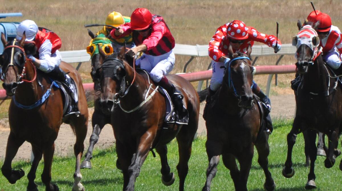 BATTLE OUT FRONT: Hugh Bowman on board Potent Force (red cap) goes head-to-head with Mathew Cahill on Cameron Crockett's Christo (red with white dots). 