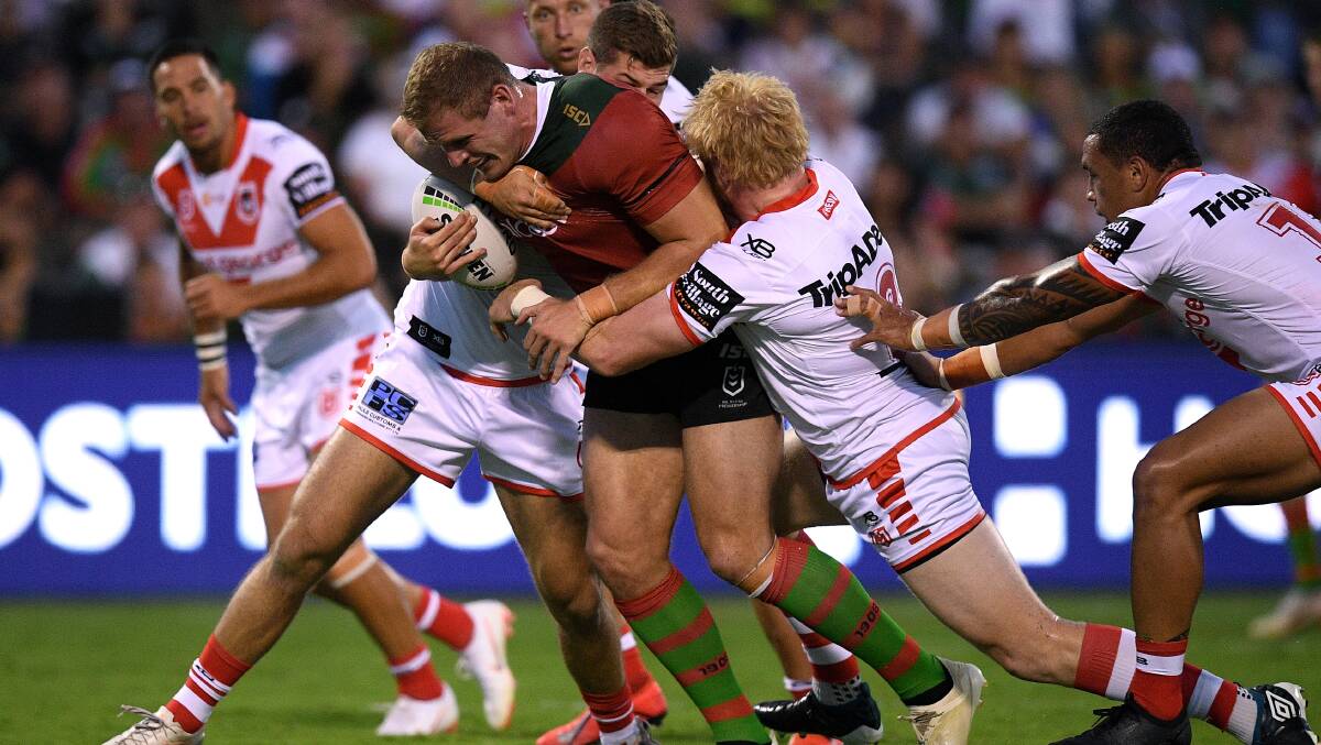 UP THE GUTS: Tom Burgess powers the ball through the Dragons forwards at Glen Willow. Photo: AAP