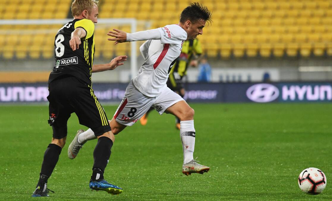 LEADING ROLE: Wanderers' Jordan O'Doherty takes on Wellington defender Mitch Nichols during Western Sydney's win in New Zealand in round three, the red and black's first victory of the A-League season. Photo: AAP/Ross Setford