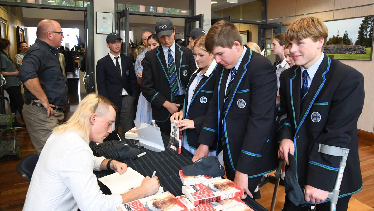 Jackson Davis and his mates get a book signed by Nedd Brockmann. Picture by Carla Freedman