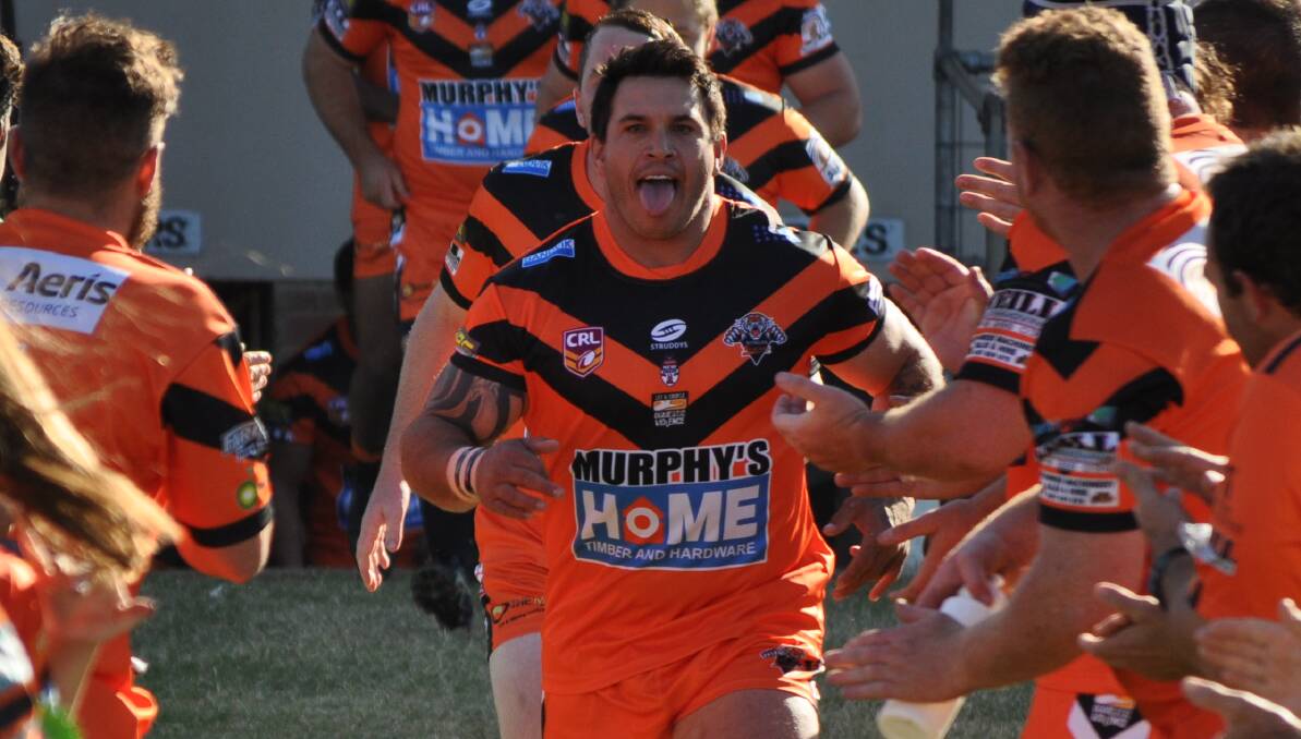 HERE WE COME: Nyngan skipper Justin Carney leads out the Tigers at Forbes on Sunday. Photo: NICK McGRATH