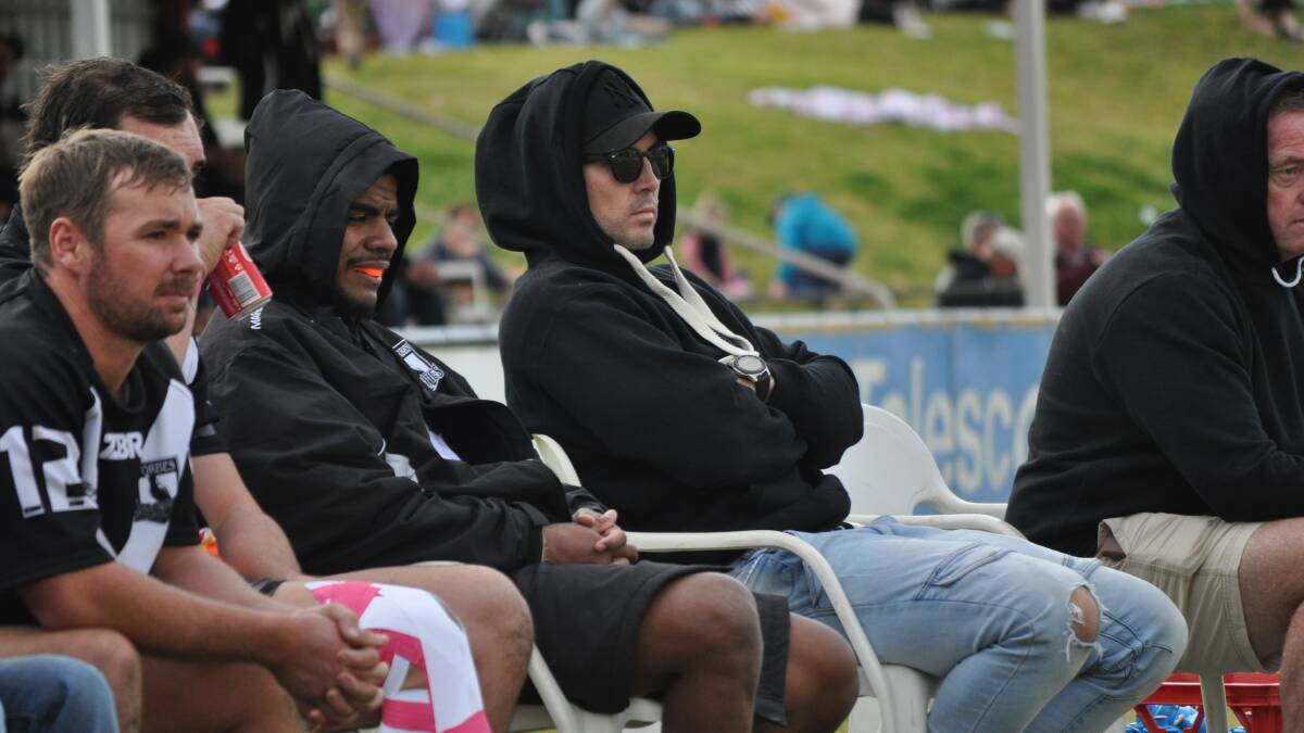 WATCHING ON: Brad McMillan (centre, wearing sun glasses) is one of a handful of injured Forbes players that coach Cameron Greenhalgh will be hoping can return to boost the premiers in the second round. Photo: NICK McGRATH