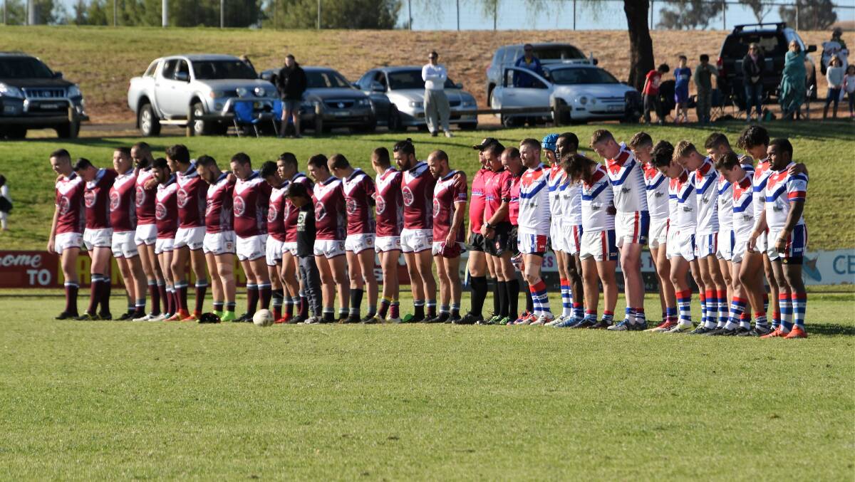 MARK OF RESPECT: The Wellington Cowboys and Parkes Spacemen observed a minute silence before kick-off of Sunday's game at Pioneer Oval. Photo: JENNY KINGHAM