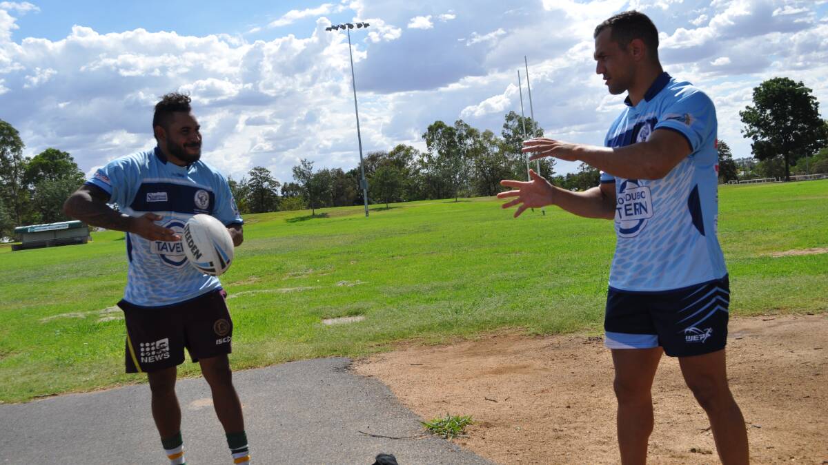 PASSING IT ON: Beau Satrick and Wes Middleton get together during the Raiders' pre-season. Photo: NICK McGRATH