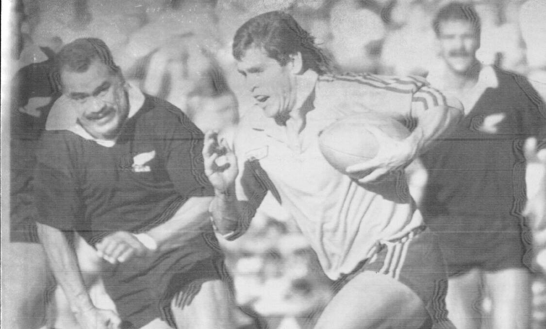 THE FLYING MULLET: James Grant slices around the outside of the All Blacks in the late 1980s. Photo: AAP