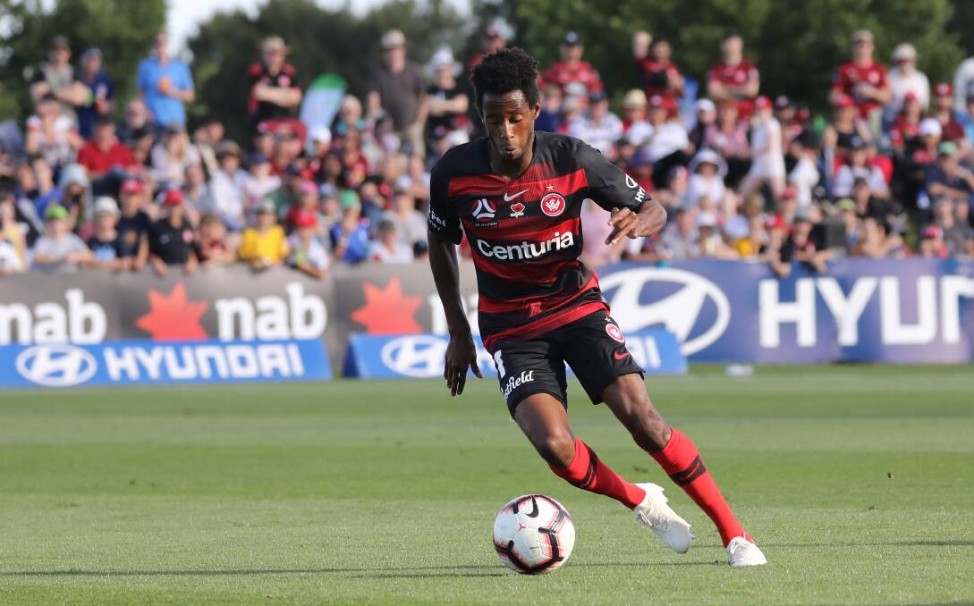 PLEASURE TO PLAY ON: Roar coach John Aloisi says the Glen Willow surfac, pictured with Wanderers' ace Brice Kamau in space, is the best in the country. Photo: SIMONE KURTZ
