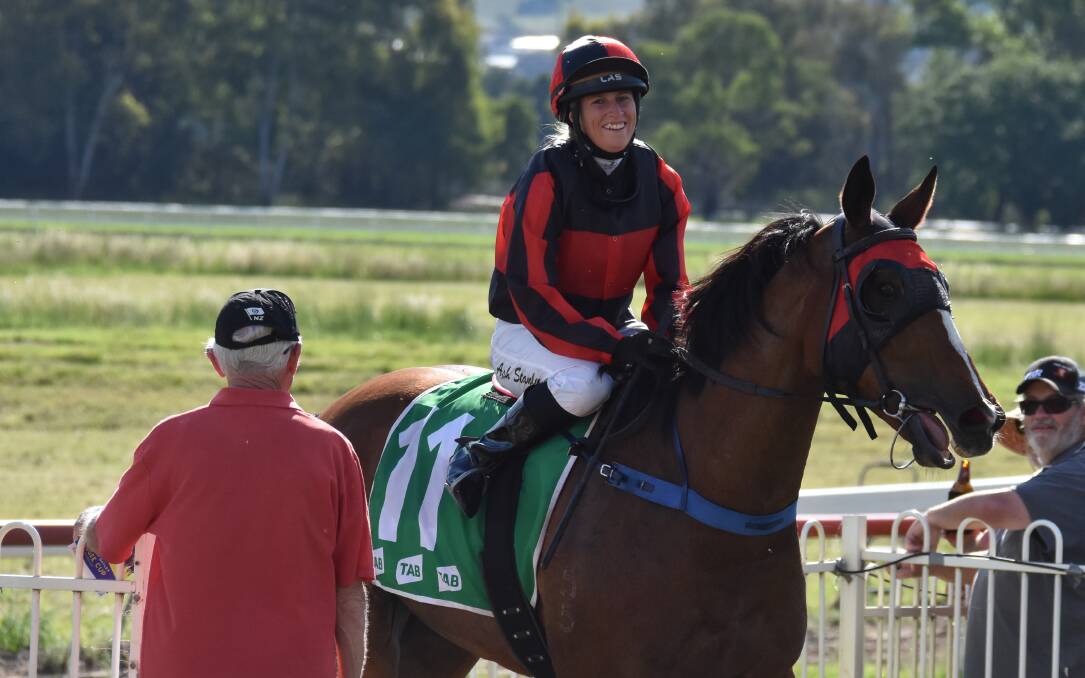 ALL SMILES: Jockey Ash Stanley is all smiles back in the parade ring after guiding Not Negotiating home in the Mudgee Cup for dad, Peter Stanley. Photo: JAY-ANNA MOBBS