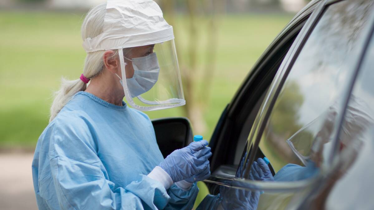 A COVID19 mobile testing station healthcare worker in full protective gear. Photo: Shutterstock