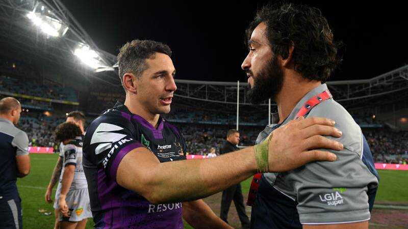 Johnathan Thurston of the Cowboys congratulates Billy Slater of the Storm as Melbourne players celebrate victory over the Cowboys during the NRL grand final in 2017.