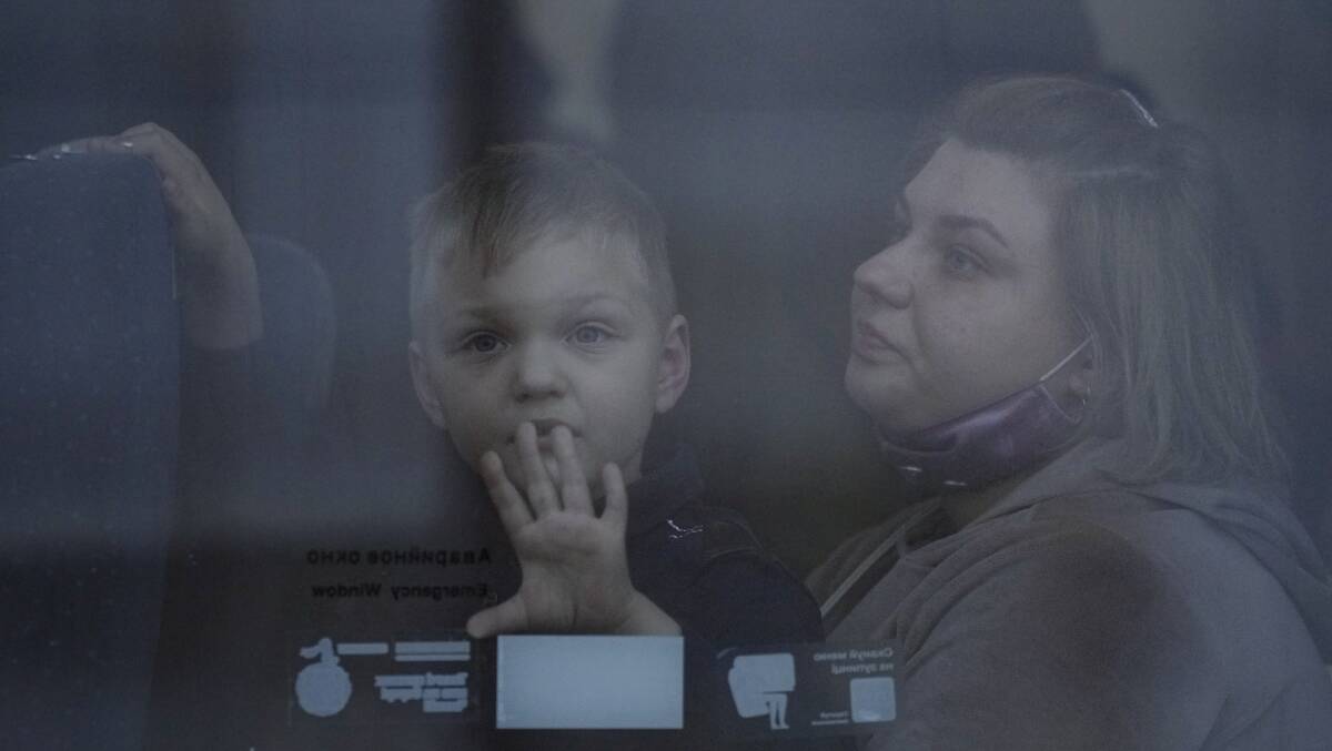 A woman and child sit on a Kyiv bound train, in Kramatorsk, the Donetsk region, eastern Ukraine. Photo: Vadim Ghirda