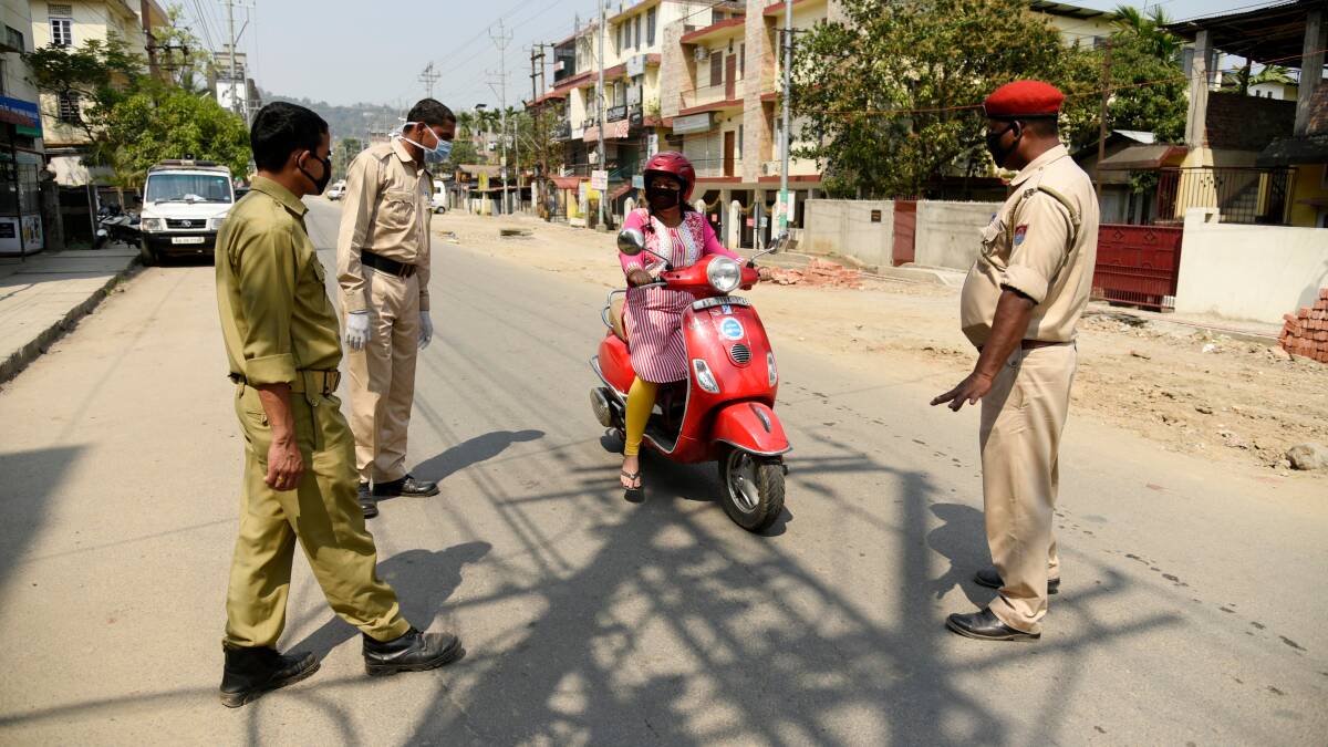  Police personnel stops commuters, during India government-imposed lockdown as a preventive measure against COVID, in Guwahati. Photo: Shutterstock