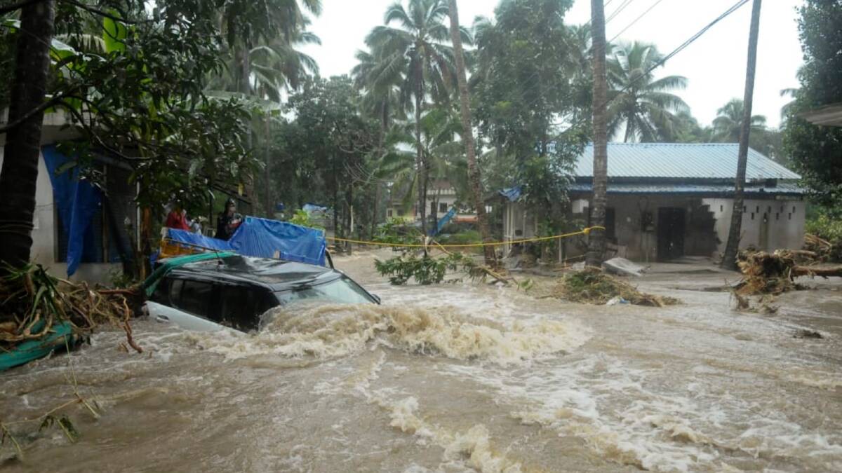 A car is submerged as roads and houses are engulfed in water following heavy rain and landslide in Kozhikode, Kerala state, India. Photo: AP